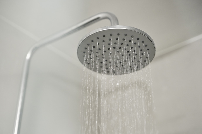  Water flows from overhead shower in bathroom.
